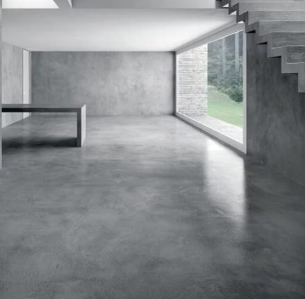 Suelo de microcemento gris continuo en salón de diseño minimalista